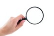 Photo: Hand holding magnifier isolated on white Hand holding magnifier isolated on white