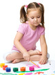 Cute cheerful child play with paints
