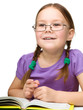 Little girl is reading a book