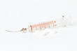Syringe and medicaments on white background.