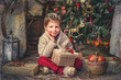 Photo: boy with a basket of toys in the background of a beautiful Chri boy with a basket of toys in the background of a beautiful Chri