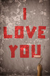 Photo: girl writing 'i love you' with paint roller girl writing 'i love you' with paint roller