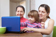 Women of three generations with netbook