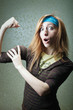 Photo: Funny sports girl touching her big biceps Funny sports girl touching her big biceps