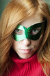Photo: redheaded young woman with green carnival mask redheaded young woman with green carnival mask