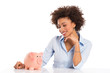 Young Woman Looking At Piggybank