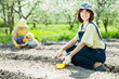  Happy women with child works at garden