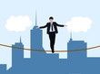 Businessman walking on rope