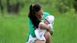 Young mother with her baby in spring garden