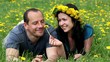 Young loving couple in a field of dandelions