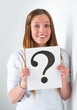 Portrait of happy student with question mark sign at campus