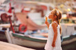 Photo: On seacoast the girl eats ice-cream. On seacoast the girl eats ice-cream.