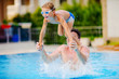 Photo: young swimmer boy on swim start at swimming pool ready for jump young swimmer boy on swim start at swimming pool ready for jump