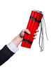 Hand holding bars of dynamite on white