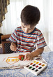 Little boy paints