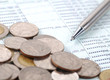 pen and coins on bank account