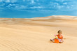 Photo: Two years old baby girl playing in a desert like in big sandbox Two years old baby girl playing in a desert like in big sandbox