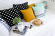 Colorful pillows on a sofa with white brick wall in background