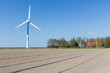 Photo: Big wind turbine in Dutch Farmland with farmhouse Big wind turbine in Dutch Farmland with farmhouse