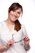 Portrait of smiling woman with glasses in her hands