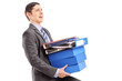 A professional man carrying heavy folders