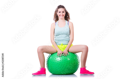 Photo: Young woman with ball exercising on white Young woman with ball exercising on white