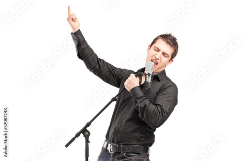 Photo: A male singer performing a song A male singer performing a song