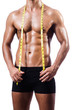 Muscular man measuring his muscles
