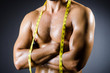 Muscular man measuring his muscles