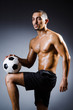 Photo : Muscular man with football ball Muscular man with football ball