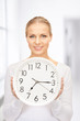 woman holding big clock