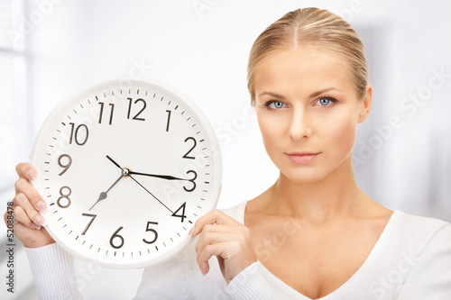 Photo: woman holding big clock woman holding big clock