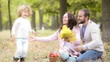 Happy family playing outdoors in autumn park