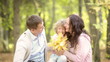 Happy family playing outdoors in autumn park