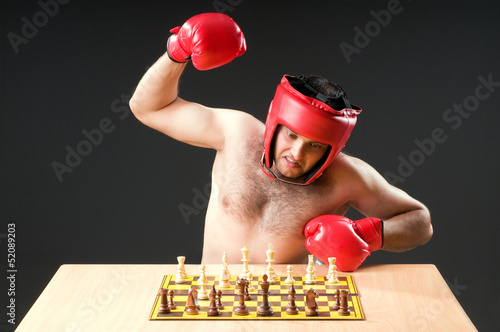 Photo: Boxer stuggling with chess game Boxer stuggling with chess game