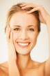 woman touching her face