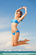 woman in bikini jumping