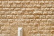 Texture of the wall built of rough yellow stone blocks