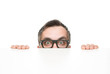 Funny nerd peeking from behind the desk isolated on white
