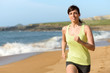 Photo: Female athlete running on beach Female athlete running on beach