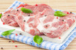 Raw steaks of pork with pepper and basil