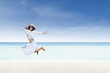 Asian tourist jump at white sand beach