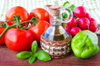Fresh spring vegetables on the table with a bottle of oil