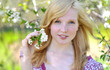 Beautiful girl in blooming tree - spring sunny portrait