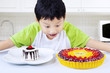 Boy eating colorful desserts at home