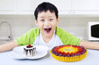 Photo: Boy laughing before eating birthday cakes at home Boy laughing before eating birthday cakes at home