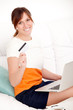Foto: woman with card in hand and laptop woman with card in hand and laptop