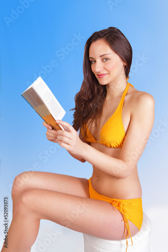 Photo: Leisure reading girl on beach holiday Leisure reading girl on beach holiday