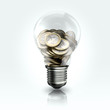 A light bulb with coins  inside