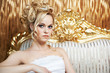 Foto: Handsome woman in gold armchair Handsome woman in gold armchair
